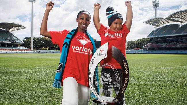 Footballer Elaine Grigg with her sister Mackayla and the Showdown Shield at Adelaide Oval. Picture: Kelly Barnes