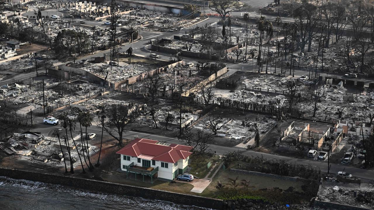 The red roofed house that survived the fires is surrounded by destroyed homes. Picture: Patrick T. Fallon / AFP