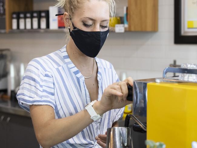 PERTH, AUSTRALIA - DECEMBER 24: A cafe worker wears a face mask on December 24, 2021 in Perth, Australia. The Western Australian government has implemented new COVID-19 restrictions, following the detection of a new community COVID-19 case. From 6pm on Thursday, masks will be mandatory in all public indoor settings in the Perth and Peel regions until December 28th. Authorities are also recommending people wear masks outdoors when physical distance can't be maintained. Large public events like music festivals have been cancelled during this period. (Photo by Matt Jelonek/Getty Images)