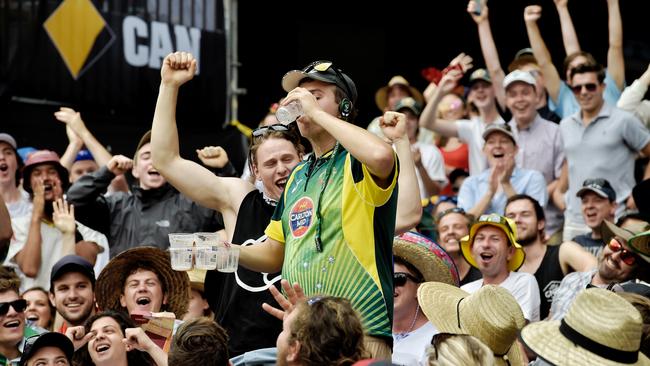 Roudy fans scull bears and do shoees. Extra security and police monitor arriving crowds at the MCG for the Boxing Day cricket Test Match. Picture: Jason Edwards