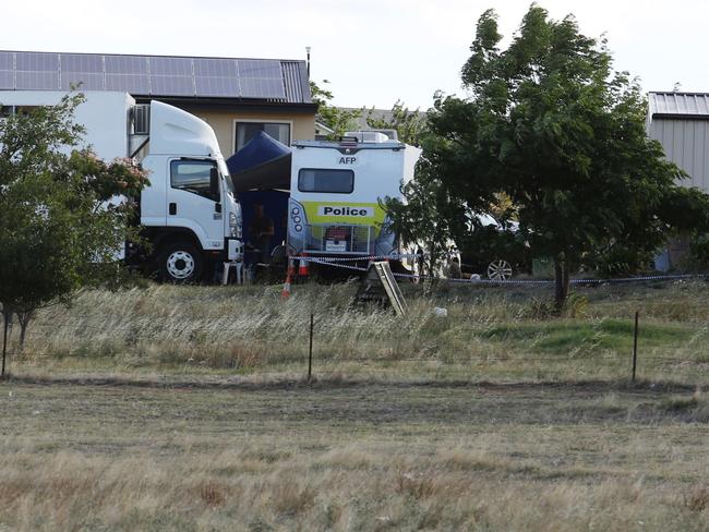 AFP and NSW Police Force officers searching the property. Picture: Brad Newman