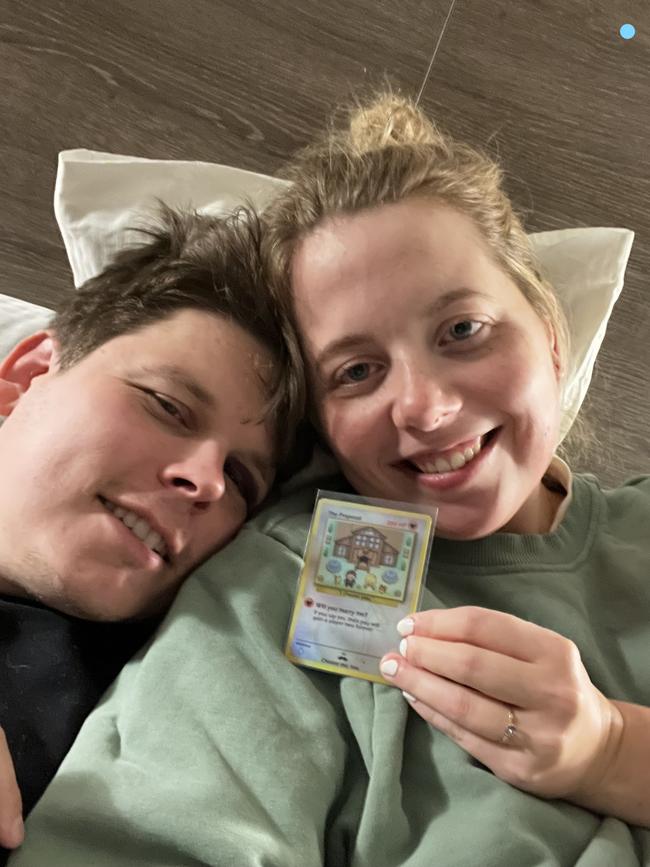 Sydney couple Josh Clements and Elysse Lloyd with their nerdy token of love. A Pokemon 'will you marry me?' card. Picture: Supplied.