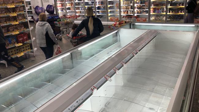 Shoppers at Coburg Coles have emptied the shelves and freezers. Picture: David Crosliing