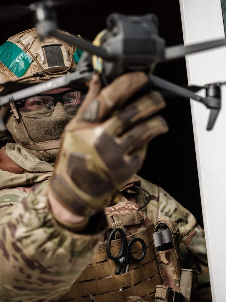 A Ukrainian serviceman demonstrates a drone with a mimic grenade. Picture: Yasuyoshi Chiba/AFP