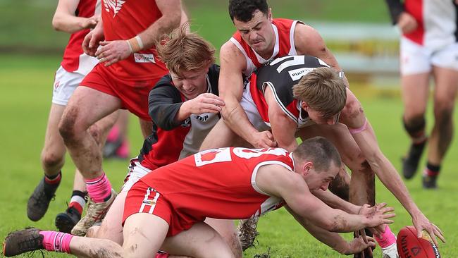 Alvie’s Sam Mahoney at the base of a big pack of players.