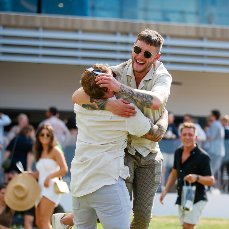 Jack Maybank (L) and Luke Powell jumping for joy as punters enjoy the 2020 Great Northern Darwin Cup. Picture: GLENN CAMPBELL