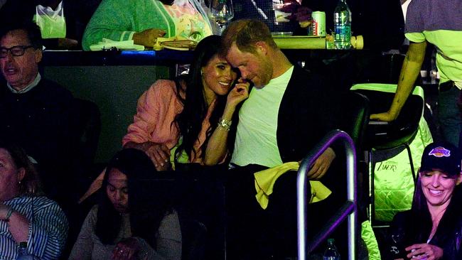 The couple whispered and smiled during the game. Picture: Allen Berezovsky/Getty Images