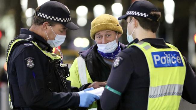 Police talk to a man.