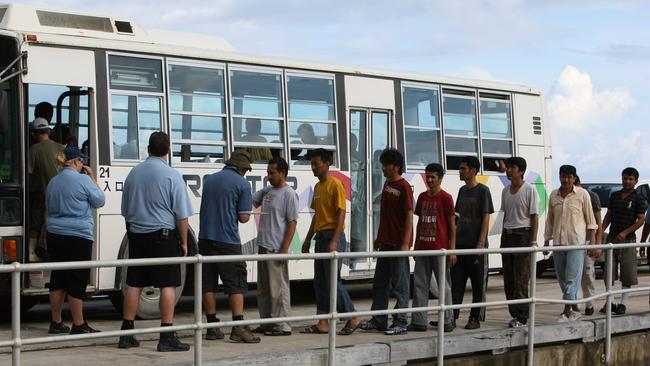 A boatload of asylum-seekers picked up by HMAS Broome arrives at the jetty on Christmas Island in 2010.