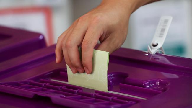 SYDNEY, AUSTRALIA - APRIL 26: A voter places their vote into a ballot box at an early voting centre in the suburb of Eastlakes in the division of Kingsford Smith ahead of the Australian Federal Election on April 26, 2025 in Sydney, Australia. Ã¢â¬â¹Early voting for the 2025 Australian election has been highly successful, with more than 524,000 people casting their ballots on the first day alone-breaking previous records and reflecting a significant increase from past elections. The Australian Electoral Commission anticipates that around half of all votes will be cast before election day, underscoring the growing popularity and effectiveness of early voting in the country. (Photo by Lisa Maree Williams/Getty Images)