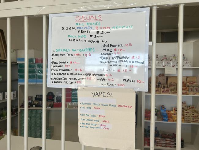 A whiteboard at a store fronting as a hair salon in Norlane displays illegal nicotine products next to prices.