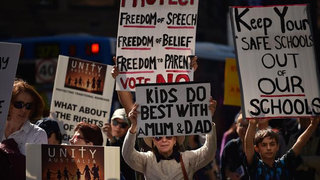 Protesters hold up banners at an anti-same-sex marriage rally in Sydney. Picture: Peter Parks/AFP