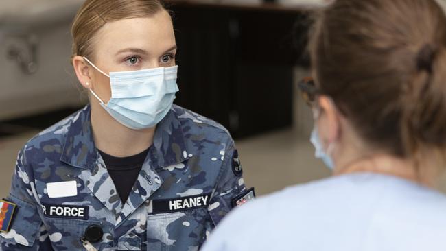 RAAF Leading Aircraft Woman Hannah Heaney talks with a NSW Health worker before receiving her COVID-19 vaccine at Royal Prince Alfred Hospital in Sydney. Picture: Defence