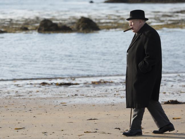 Churchill (Cox) cuts a solitary figure on the beach as he recalls Gallipoli. Picture: Graeme Hunter