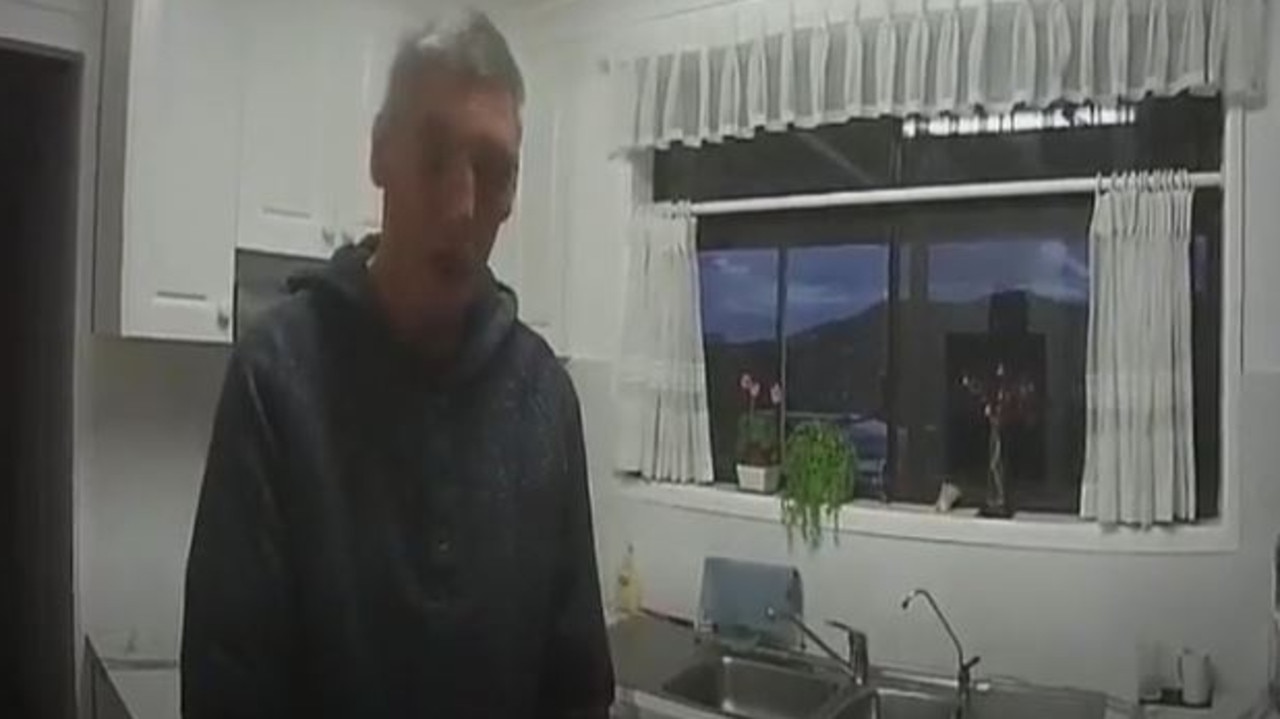 Mapp speaks to police at the home as his mum lies dead just metres away. Picture: NSW Police
