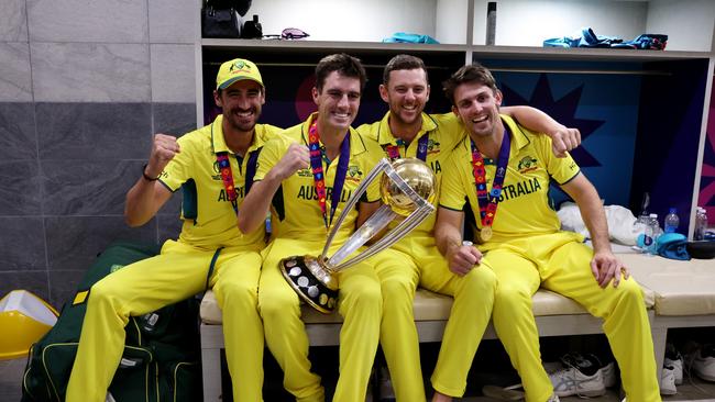 AHMEDABAD, INDIA - NOVEMBER 19: Mitchell Starc, Pat Cummins, Josh Hazlewood and Mitch Marsh of Australia pose with the ICC Men's Cricket World Cup following the ICC Men's Cricket World Cup India 2023 Final between India and Australia at Narendra Modi Stadium on November 19, 2023 in Ahmedabad, India. (Photo by Robert Cianflone/Getty Images)