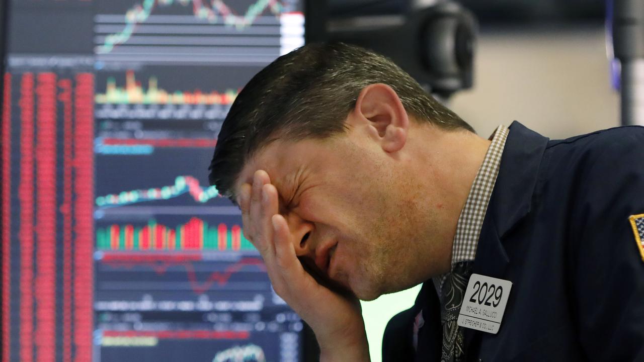 A Wall Street trader grapples with the rollercoaster market. Picture: AP