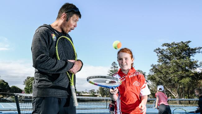 Henley South Tennis Club coach David Grainger with Sienna Molloy, 9. Picture: AAP/Morgan Sette