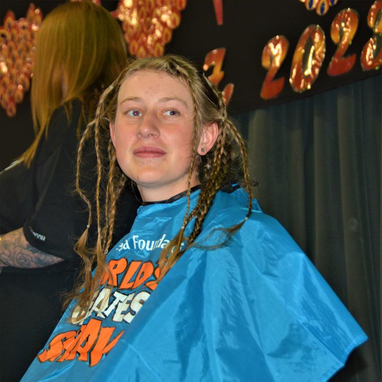 At the St Joseph's College 2023 World's Greatest Shave event is student Emily Chandler getting her hair cut by her support crew and hairdresser Natalie Schmidt from the Hair Room on Russell. Picture: Rhylea Millar