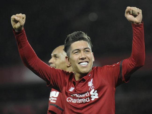 Liverpool's Roberto Firmino celebrates after he scores his sides 5th goal and his 3rd from the penalty spot during the English Premier League soccer match between Liverpool and Arsenal at Anfield in Liverpool, England, Saturday, Dec. 29, 2018. (AP Photo/Rui Vieira)