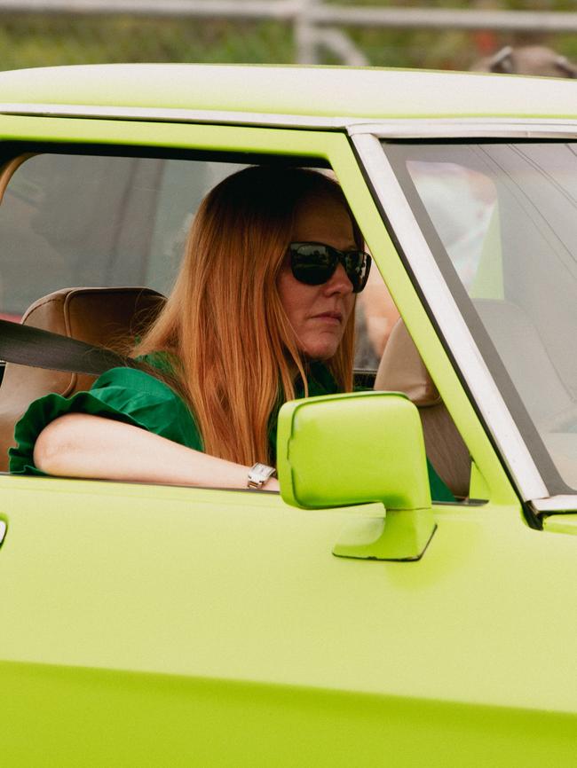 A vintage car driver takes part in the parade at the 2023 Gayndah Orange Festival.