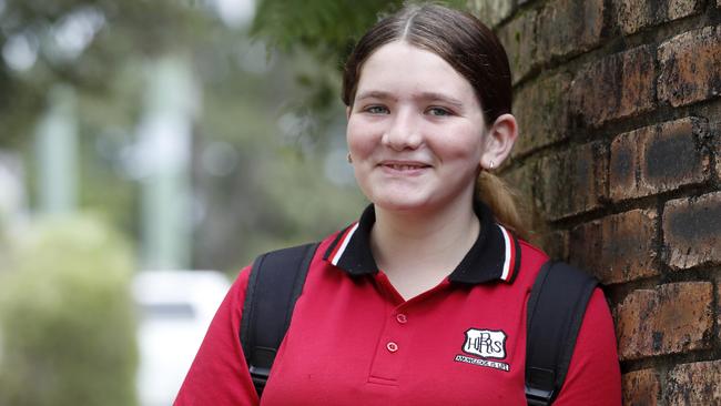 Richmond River High Campus student Mihaela Butcher, 14, from Goonellabah, near Lismore, is beaming at the prospect of going back to school on Monday to see her friends. Students will share the Lismore High School grounds until her school is rebuilt. Picture: Jonathan Ng