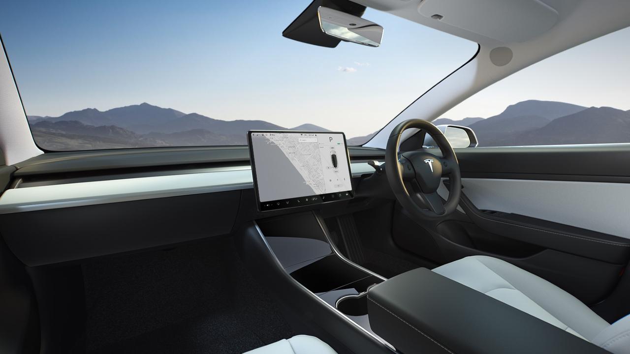 A small camera near the Tesla Model 3’s mirror monitors driver behaviour.