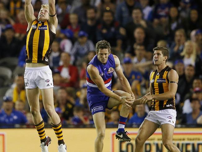 The moment no footy fan wanted to see. Bob Murphy grabs his knee in round 3 of the 2016 season, forcing him out for the year as his Bulldogs went on to win the flag. Picture: Michael Klein