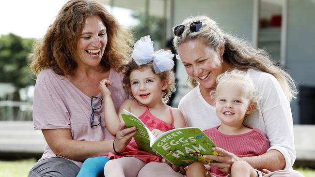 Rebecca Jackes and her daughter Chloe Jackes, 3, with friends Eloise Pillemernt and her daughter Azalea, 3, reading a Dr. Seuss book at Centennial Park. Picture: Jonathan Ng