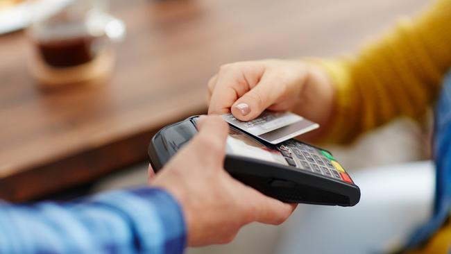 Close-up of unrecognizable customer choosing contactless payment using credit card while waitress accepting payment over nfc technology