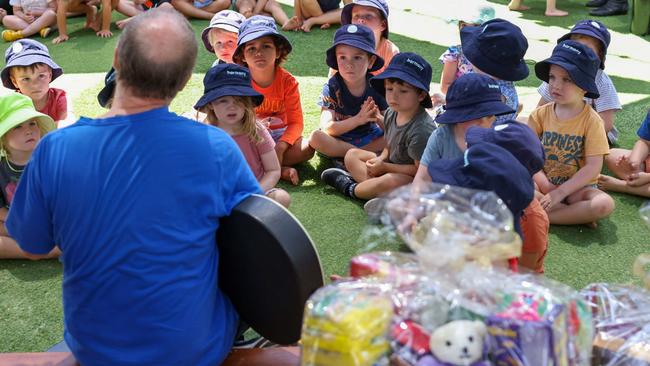 Lismore chaplain Ian Phillips teaching the kids at Harmony ELJ Lennox about the gift of giving, with the help of his trusty guitar.