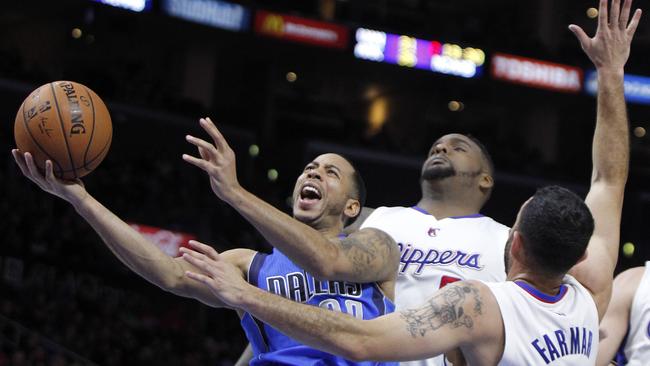 Dallas Mavericks guard Devin Harris, left, shoots against Los Angeles Clippers forward Glen Davis, centre, and guard Jordan Farmar (1) during the second half.