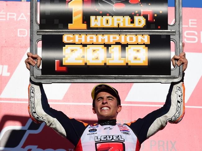 Repsol Honda Team Spanish rider Marc Marquez celebrates on the podium of the MotoGP Japanese Grand Prix at Twin Ring Motegi circuit in Motegi, Tochigi prefecture on October 21, 2018. - Honda's Marc Marquez stormed to victory in a nail-biting Japan race on October 21 to capture his third straight MotoGP world title. (Photo by Martin BUREAU / AFP)