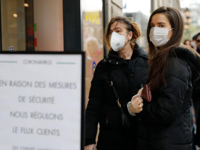 A line of customers wait to enter a supermarket in France, as only 30 people are allowed in at the same time. Picture: AFP