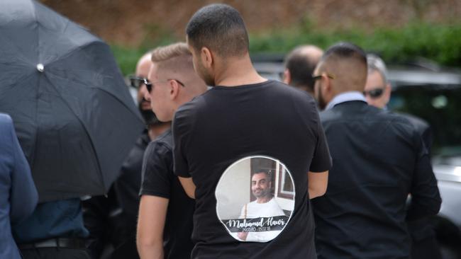 A mourner with a shirt featuring a photo of Mick Hawi. Picture: Jeremy Piper.