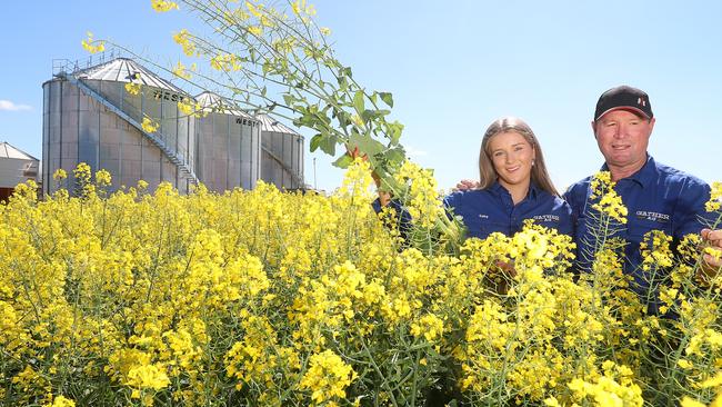 Tim Dowling &amp; his daughter Gaby with their canola crop. Picture: Yuri Kouzmin