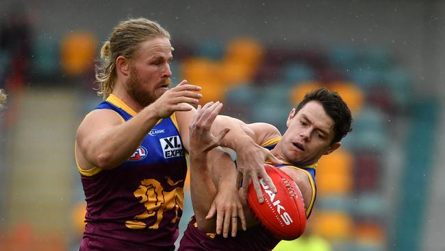 Lions stars Daniel Rich (left) and Lachie Neale (right) are ready to take on Port Adelaide before heading interstate for an indefinite period. Picture: AAP Image/Darren England