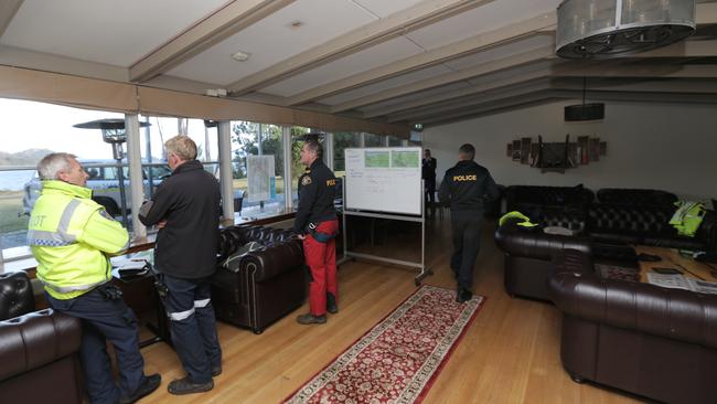 Search co-ordinators inside the command centre at Pedder Wilderness Lodge. Picture: LUKE BOWDEN