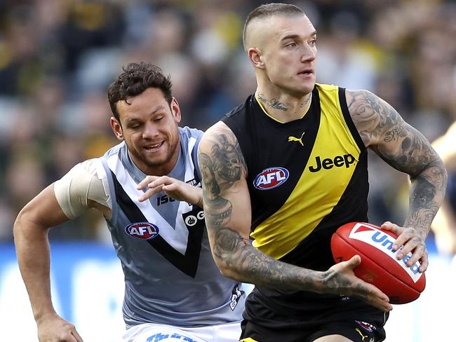 MELBOURNE, AUSTRALIA - JULY 20: Dustin Martin of the Tigers in action ahead of Steven Motlop of the Power during the 2019 AFL round 18 match between the Richmond Tigers and the Port Adelaide Power at the Melbourne Cricket Ground on July 20, 2019 in Melbourne, Australia. (Photo by Dylan Burns/AFL Photos)