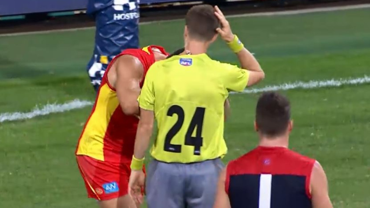Gold Coast's Steven May makes contact with umpire Davis Harris.