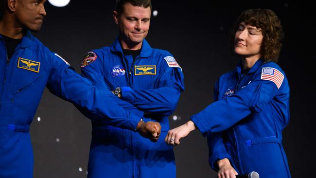 Astronauts Christina Hammock Koch (R), Victor Glover (L) and Jeremy Hansen (C) react after being selected for the Artemis II mission. Picture: Mark Felix / AFP)