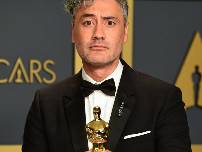 Taika Waititi poses in the press room with the Oscar for Best Adapted Screenplay for 