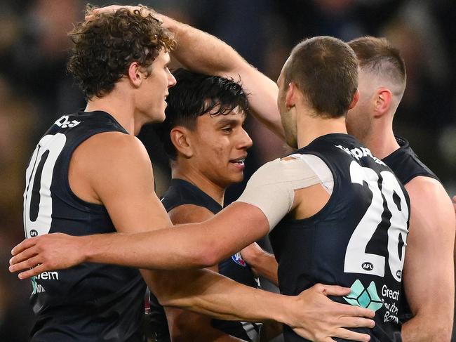 MELBOURNE, AUSTRALIA - JULY 15: Charlie Curnow, Jesse Motlop and David Cuningham of the Blues celebrate a goal during the 2023 AFL Round 18 match between the Carlton Blues and the Port Adelaide Power at Marvel Stadium on July 15, 2023 in Melbourne, Australia. (Photo by Morgan Hancock/AFL Photos via Getty Images)