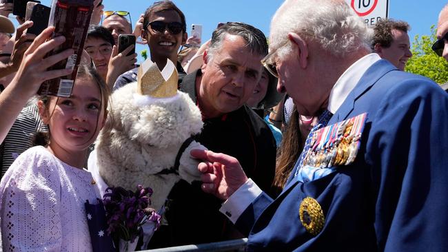 The King meets a toy alpaca. Picture: AFP