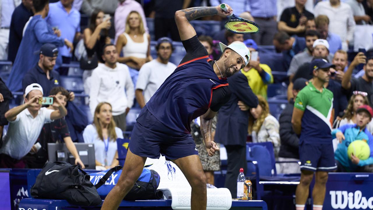 Nick Kyrgios of Australia smashes his racket after being defeated by Karen Khachanov .