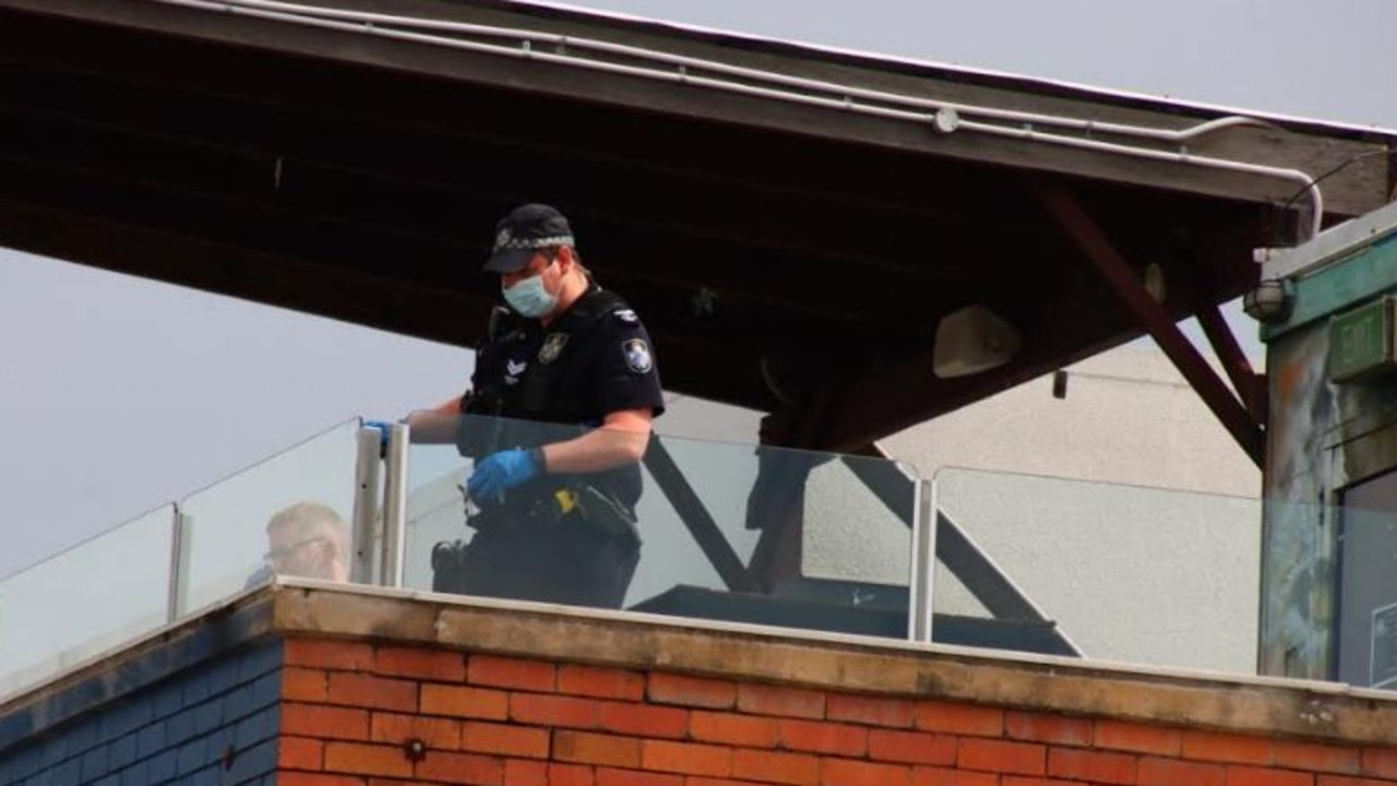 A police officer collects evidence at the scene of the fall. Picture: David Clark