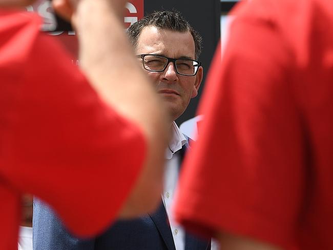 Victorian Premier Daniel Andrews (centre) is seen alongside Labor party supporters wearing red shirts at Deer Park train station in Melbourne, Thursday, November 22, 2018. Victorians go to the polls on Saturday. (AAP Image/Julian Smith) NO ARCHIVING