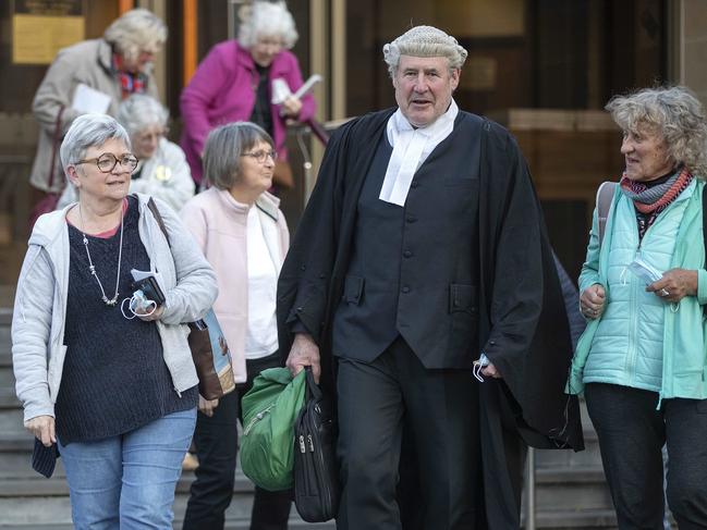 John Munro, solicitor for Jeffrey Thompson, leaving the Supreme Court of Tasmania with Sue Neill- Fraser supporters. Picture: Chris Kidd