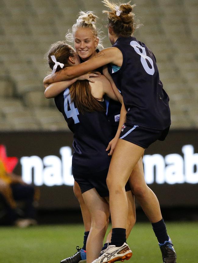 Vic Metro’s Brooke Struylaart (middle) celebrates with Isabel Huntington and Anna Hayes. Picture: George Salpigtidis