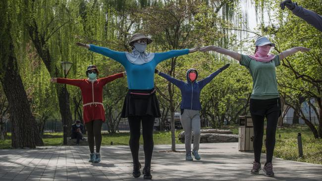 Women wear dance for exercise while enjoying the spring weather in Beijing. Picture: Getty Images